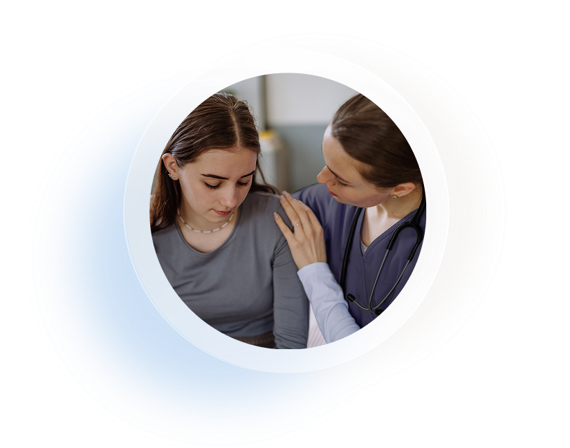 Nurse comforting young patient