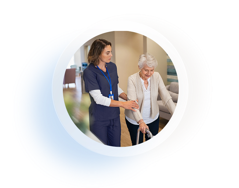 Aged care worker helping resident walk