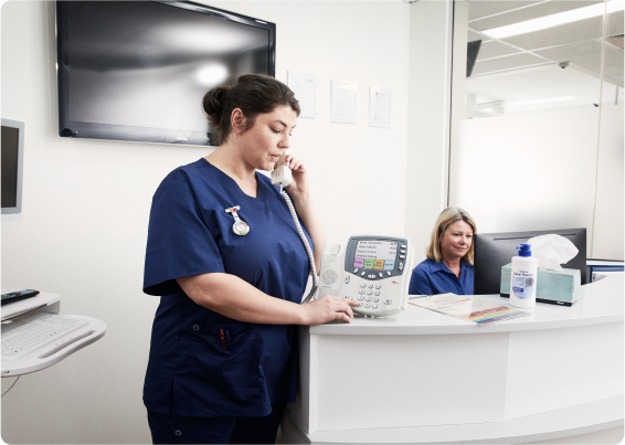 Care Team talking about a screen in a huddle 3