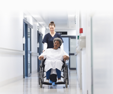 Nurse pushing resident in wheelchair