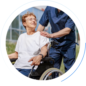 Carer pushing resident in wheel chair