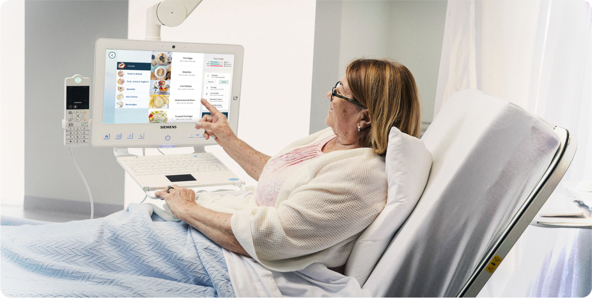 Patient in hospital using Concierge HiMed patient entertainment system