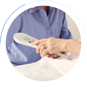 Elderly resident pressing on responder nurse call remote
