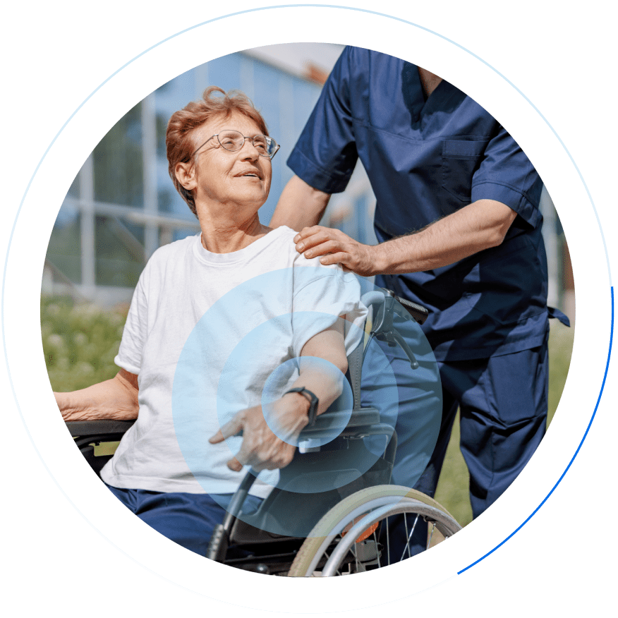 Carer pushing resident on wheelchair